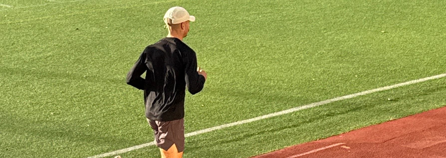 A runner training on an athletics track.